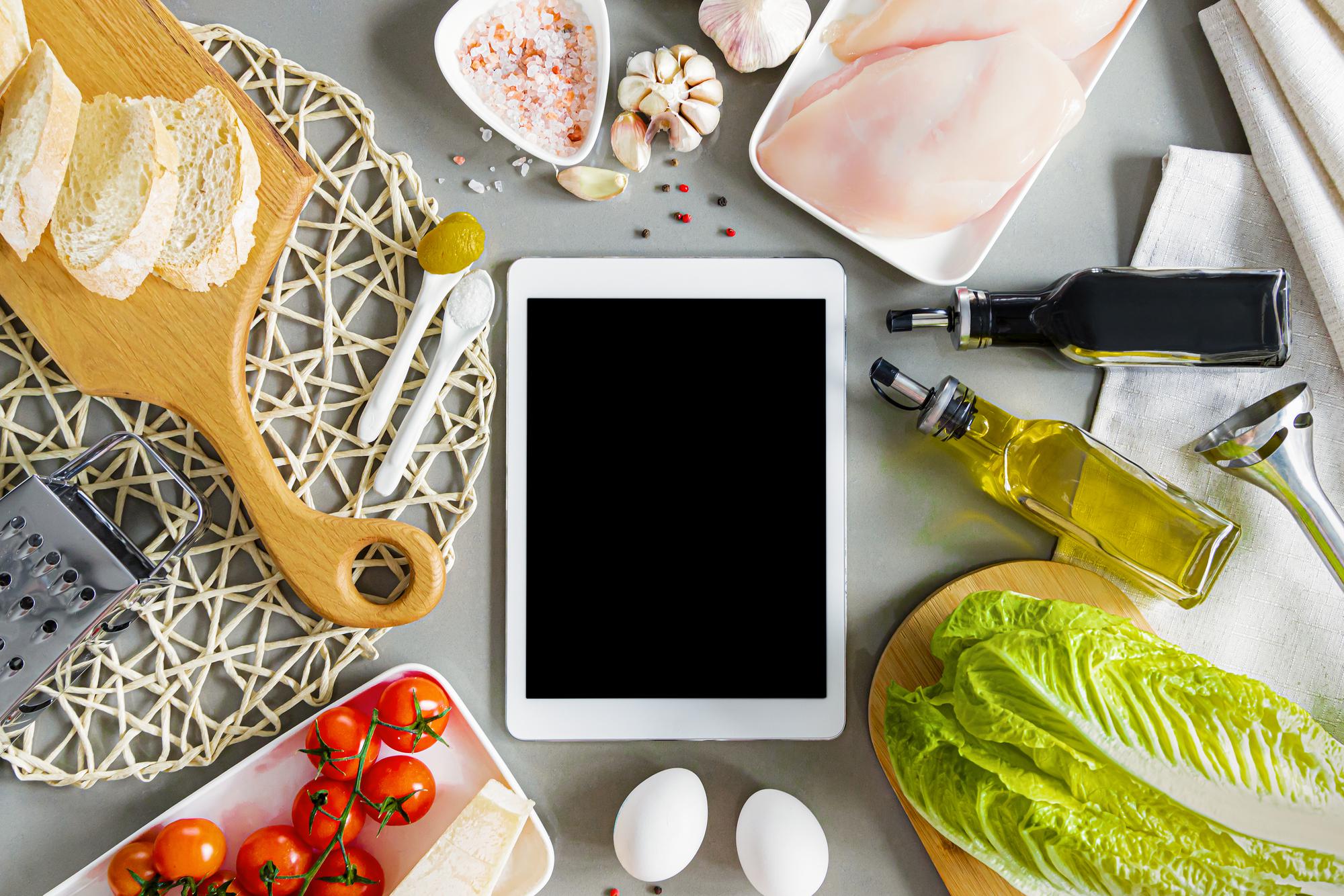 flatlay of packaged meals and analytics tablet